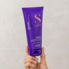 ALFAPARF MILANO being applied to damp hair in salon to reduce brassiness and hydrate
