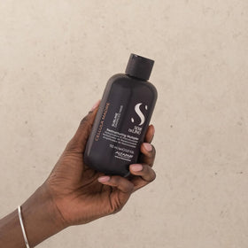 ALFAPARF MILANO applying emulsion to hair strands to restore strength benefit