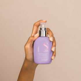 Alfaparf Milano cream applied to damp hair demonstrating frizz control benefit