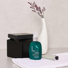 ALFAPARF MILANO held in hand to show compact size and travel-friendly benefit