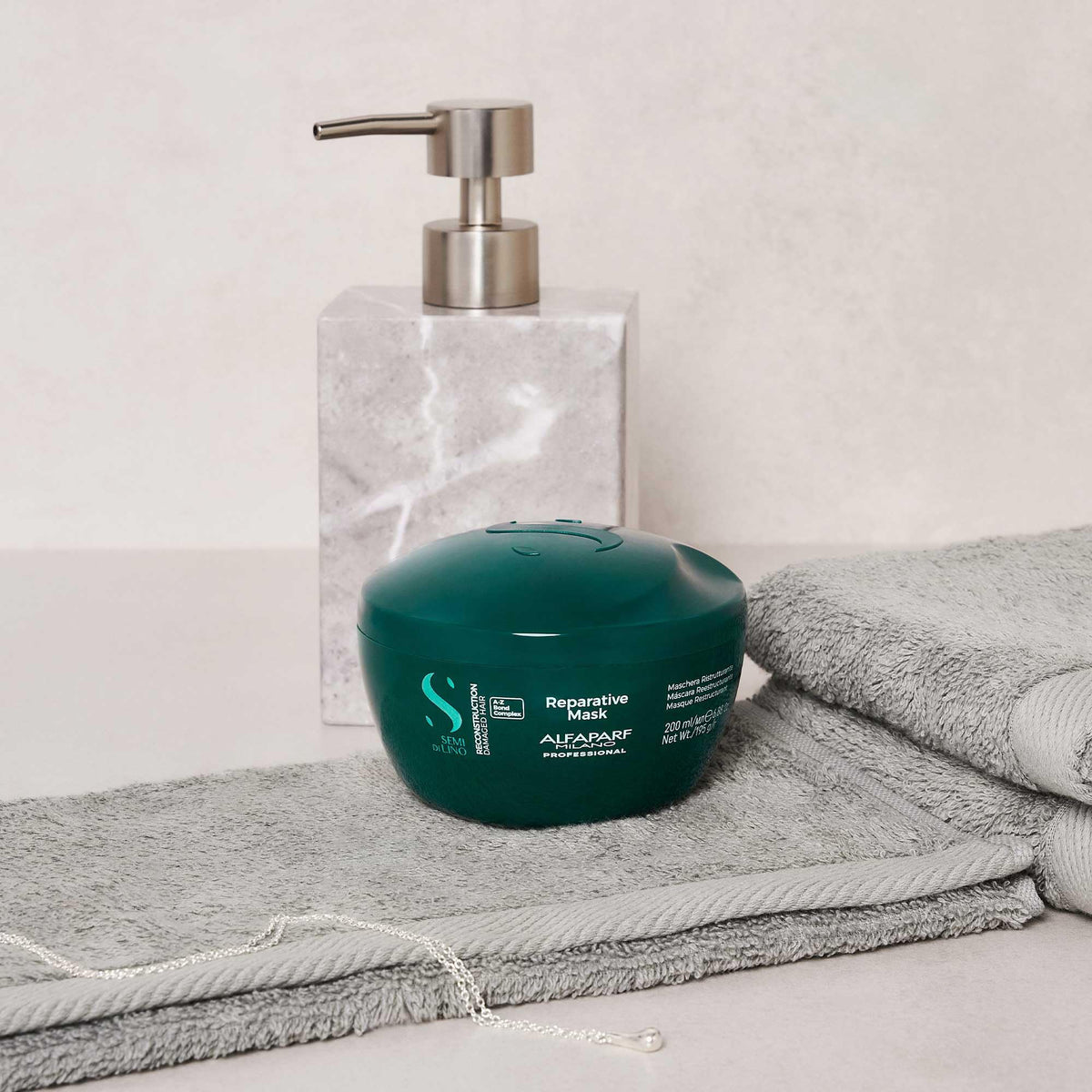 ALFAPARF MILANO jar in hand showing size and convenience for at‑home use