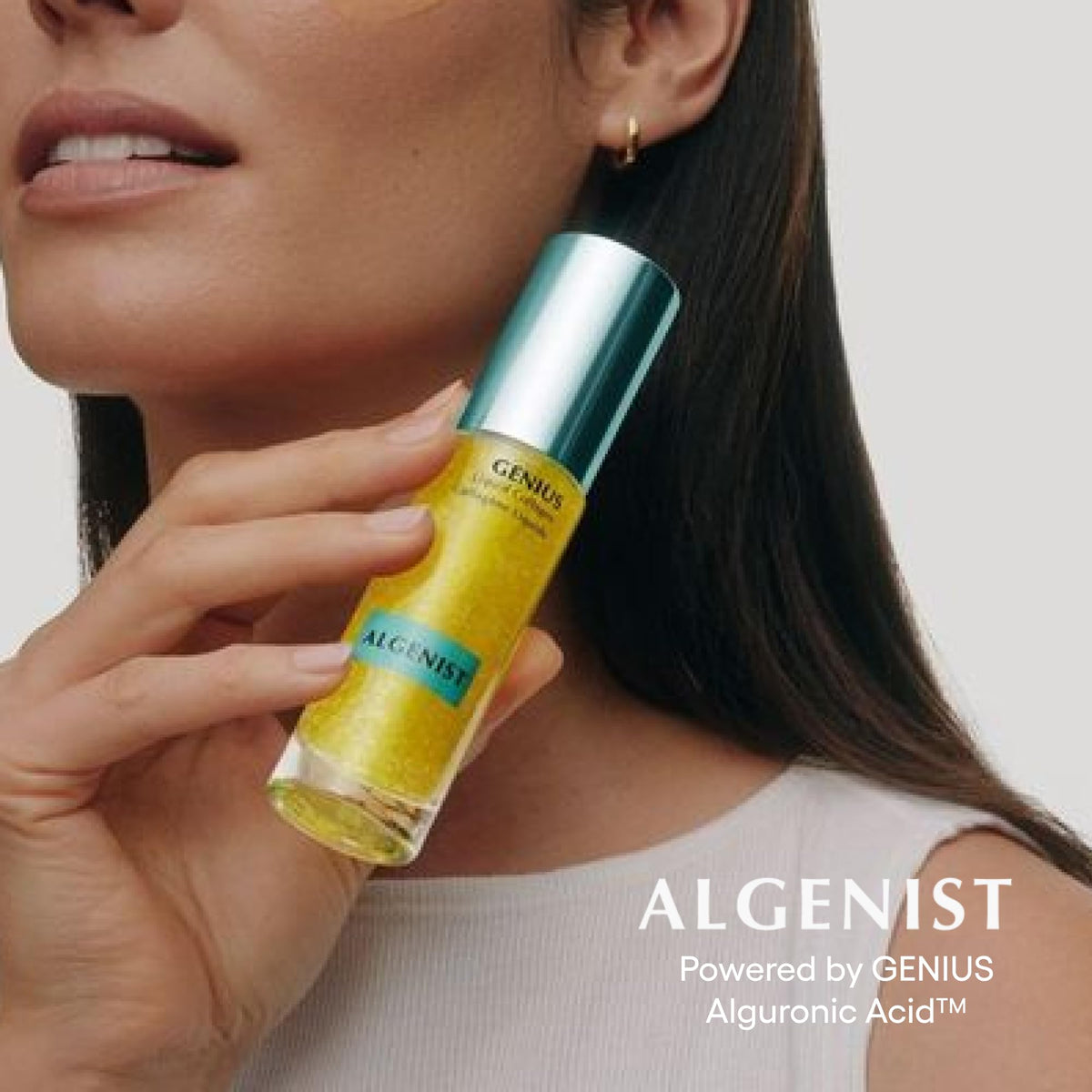 Algenist serum held in hand to show 1 oz scale and convenient travel benefit