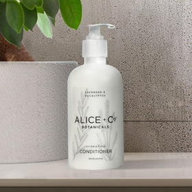 Alice + Co. bottle placed on hotel bathroom shelf conveying luxury feel