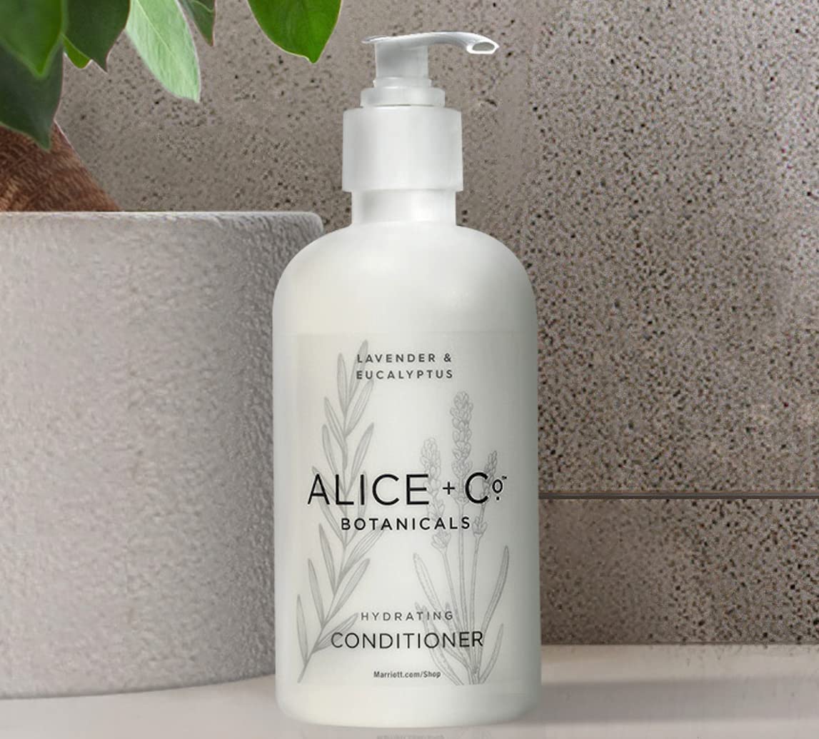 Alice + Co. bottles beside travel bag for packing ease and portable benefit