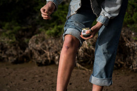 All Good Goop next to outdoor gear illustrating practical everyday carry benefit