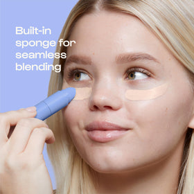 ALLEYOOP concealer beside a makeup bag to show travel-size convenience and portability