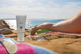 Aloe Up on beach towel with sunglasses, outdoor water-resistant protection