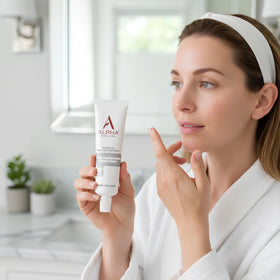 Alpha applying cream to cheek to show usage and evening routine benefit