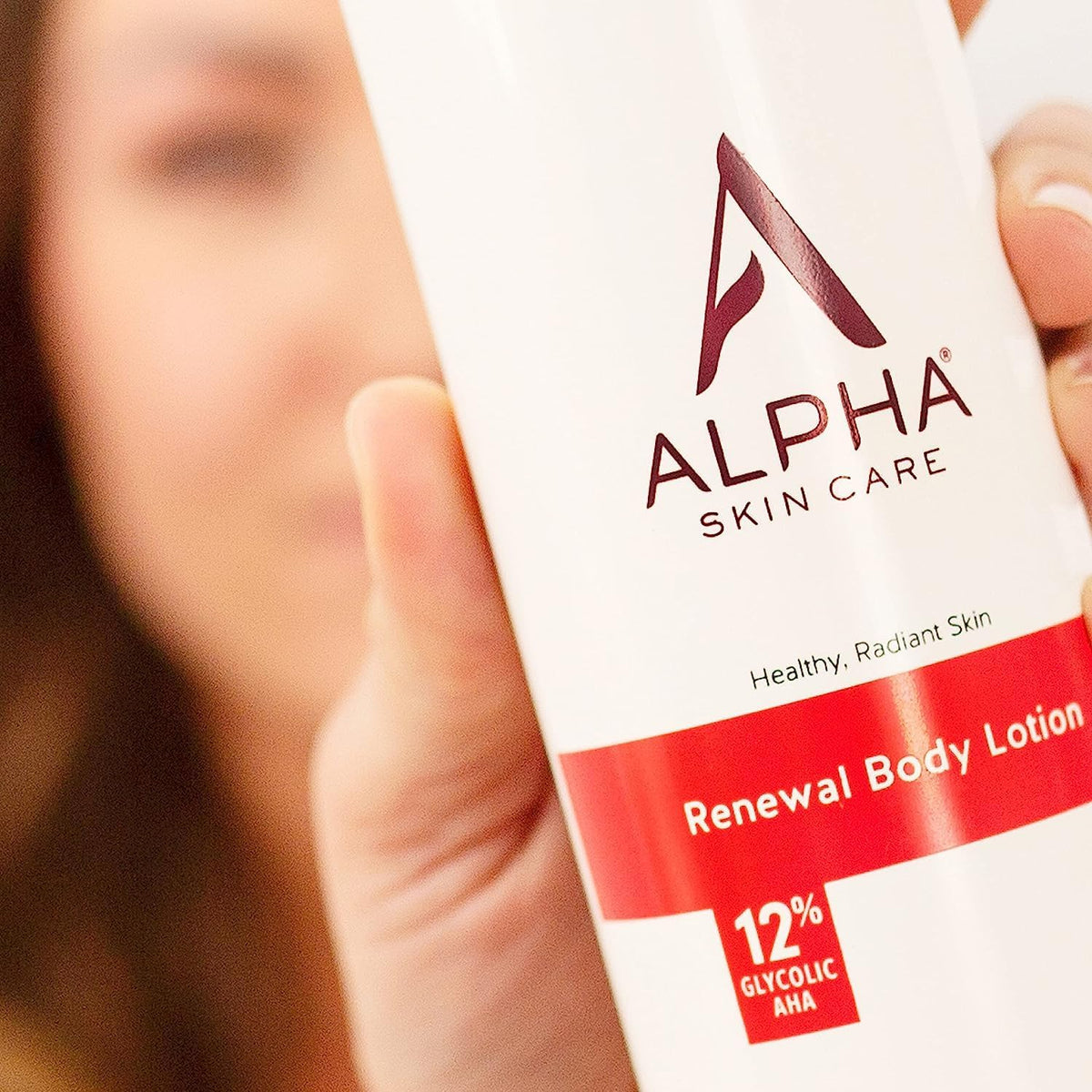 Alpha size comparison with hand showing 12 oz bottle scale