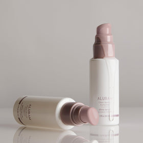 ALURAM serum texture on hand highlighting lightweight absorption and shine