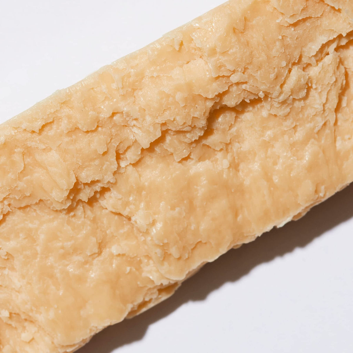 Ambi cocoa butter bar held in hand to demonstrate 3.5 oz size and comfortable grip