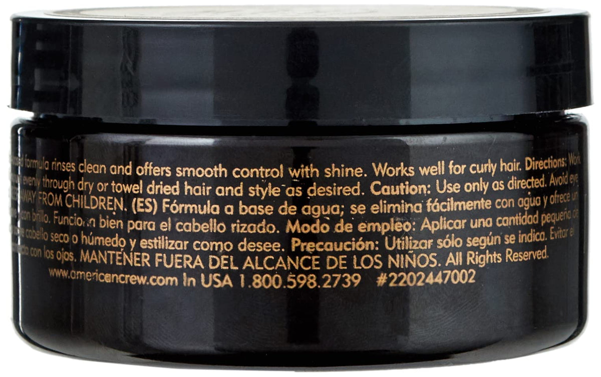 American Crew pomade in use on model slicked-back style, providing glossy finish and control