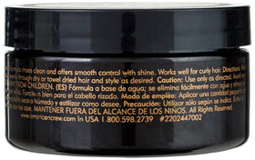 American Crew pomade in use on model slicked-back style, providing glossy finish and control