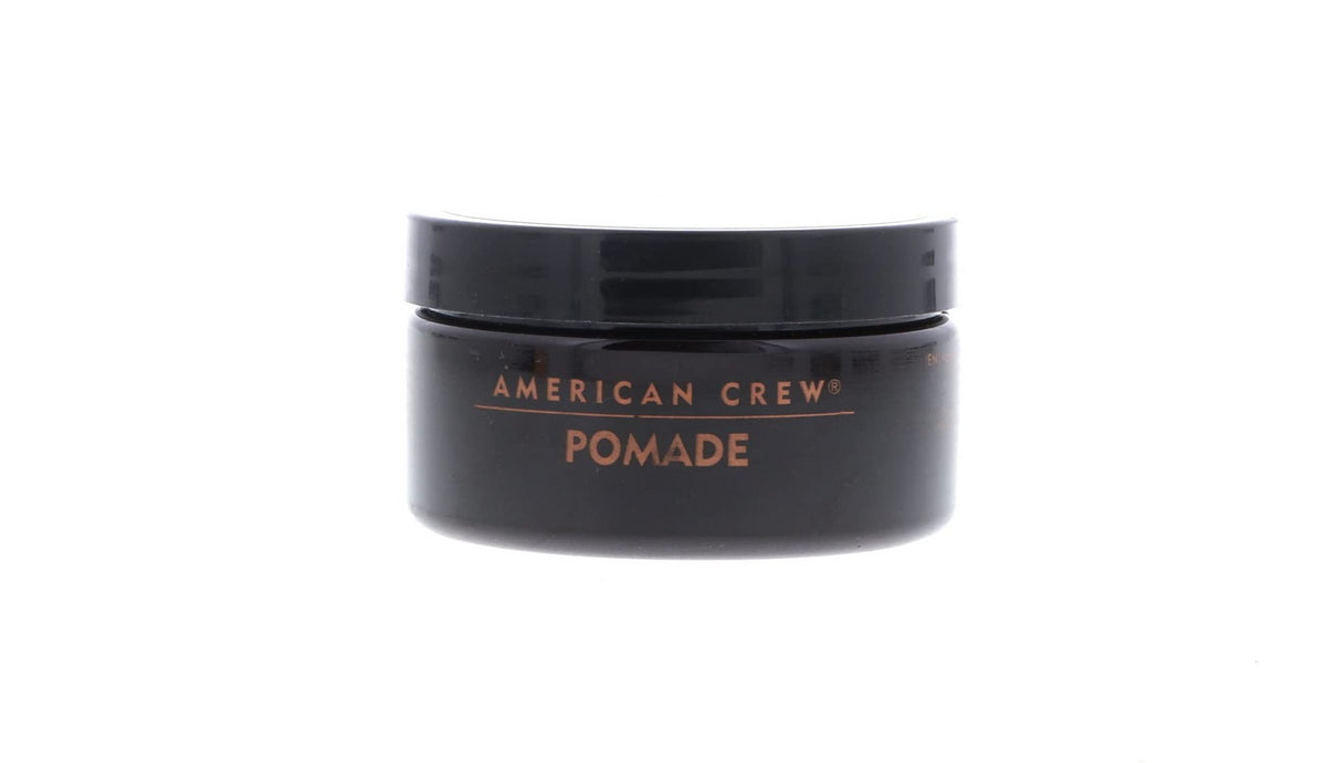 Model with American Crew pomade slicked-back style showing polished shine benefit