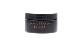 Model with American Crew pomade slicked-back style showing polished shine benefit
