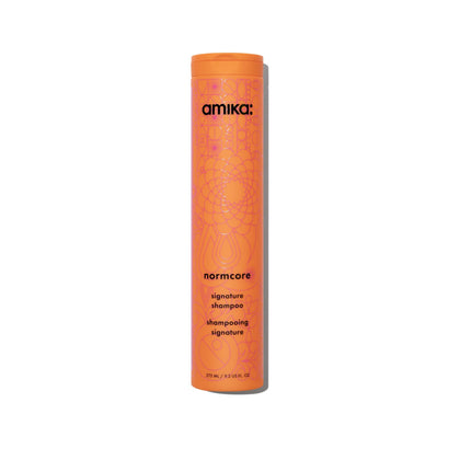 Amika Normcore front bottle view showing clean branding and easy-pour cap benefit