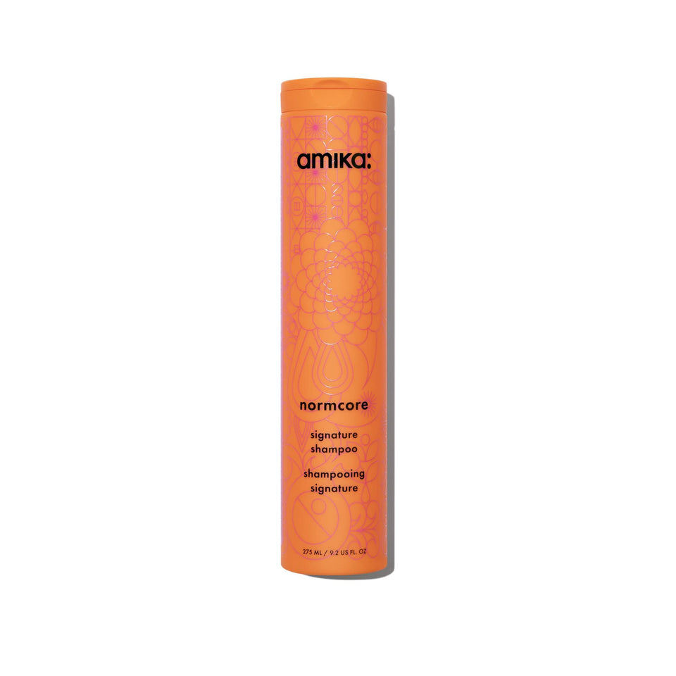 Amika Normcore front bottle view showing clean branding and easy-pour cap benefit