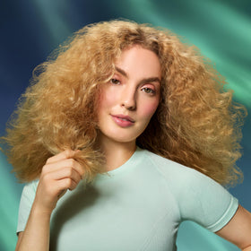 amika The Closer styled hair lifestyle image showing smoother, healthier-looking ends