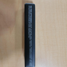 Anastasia Beverly Hills gloss next to coin to display compact size and travel-friendly fit