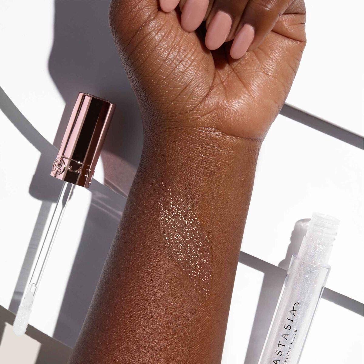 Anastasia Beverly Hills gloss paired with lipstick to show layering possibilities and depth