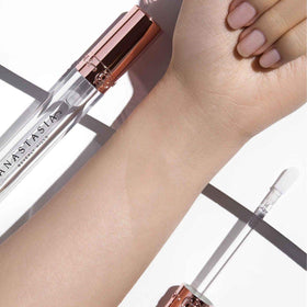 Anastasia Beverly Hills gloss on model lips illustrating fuller-looking, luminous result