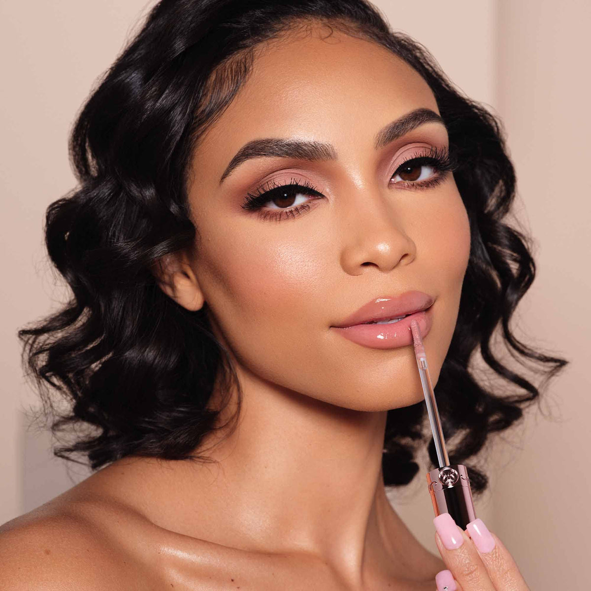 Anastasia Beverly Hills gloss in lifestyle setting conveying everyday wearability