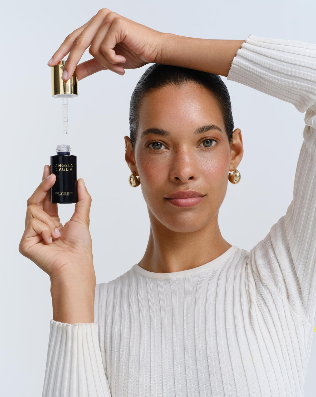 Angela Caglia pipette dispensing clear serum highlighting precise application control