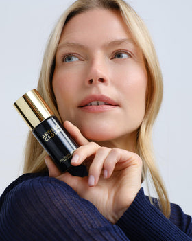 Angela Caglia serum on palm illustrating lightweight feel and immediate hydration benefit