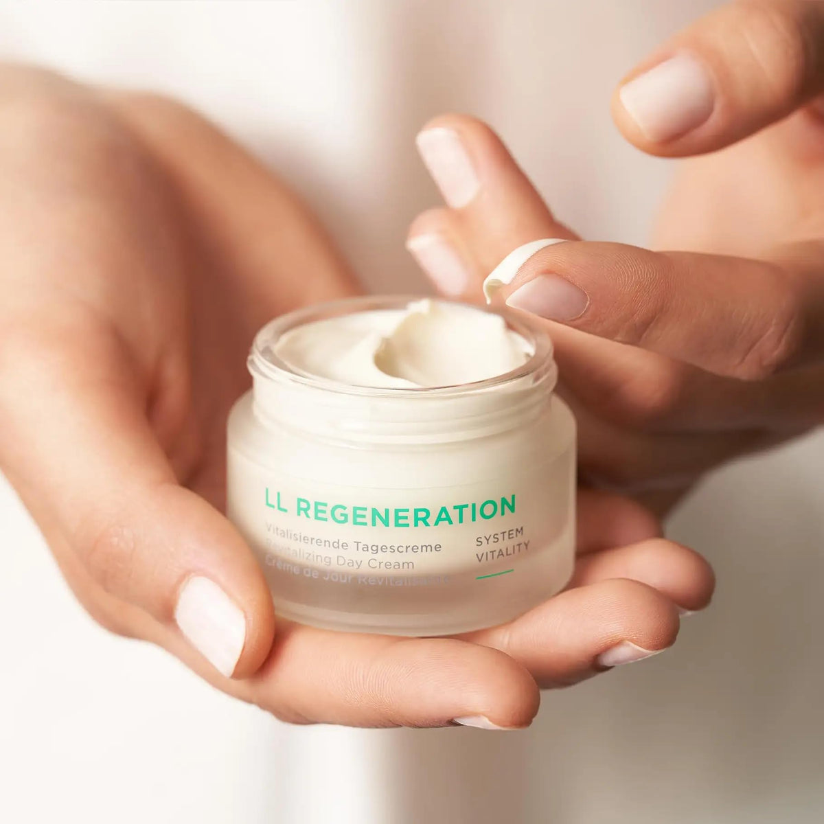 ANNEMARIE BÖRLIND applying cream to cheek demonstrating smooth absorption