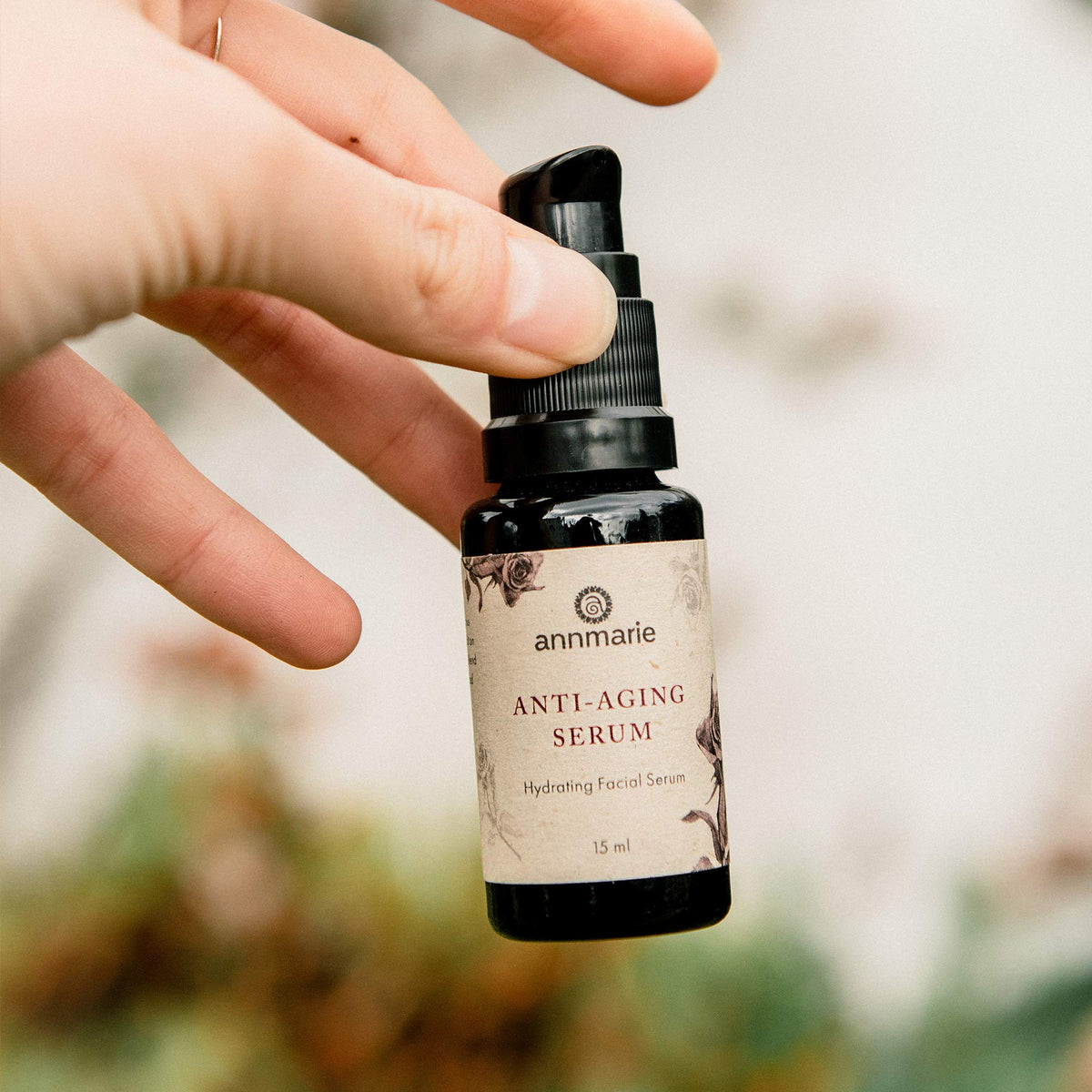 annmarie bottle beside passport for scale illustrating travel-friendly 15ml convenience