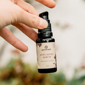 annmarie bottle beside passport for scale illustrating travel-friendly 15ml convenience