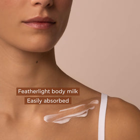 Apivita applying body milk on arm demonstrating smooth absorption and softness