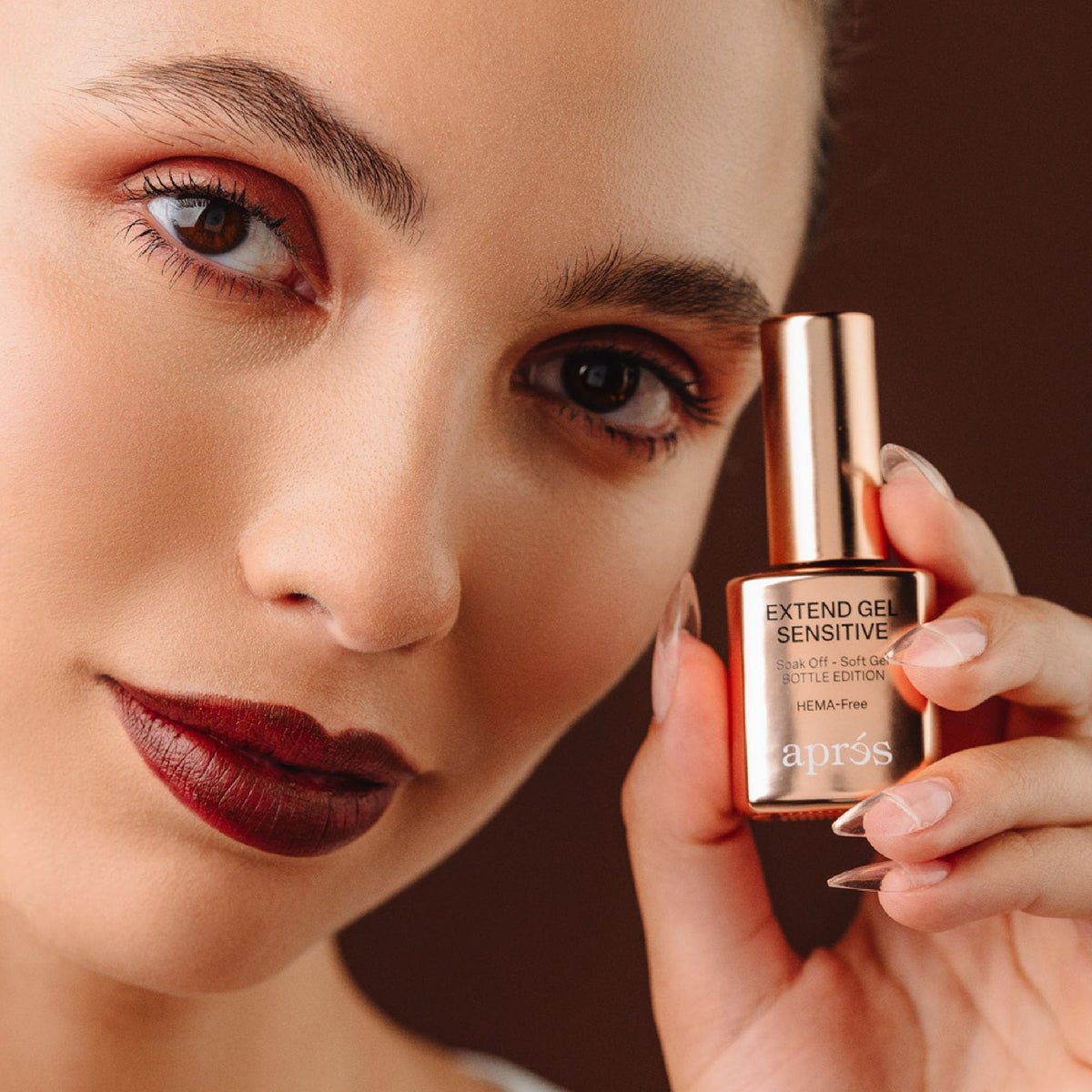 APRÉS bottle in hand to show 15ml scale and professional-ready size benefit