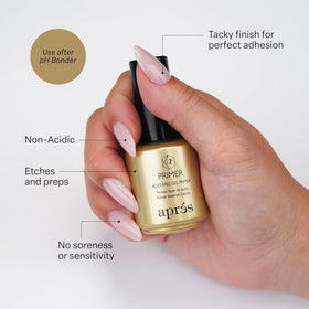 APRÉS pH Bonder being applied to a natural nail for improved adhesion