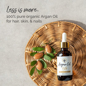 Argan Cosmetics bottle beside a ruler to show 2 fl oz scale and travel-friendly size benefit