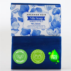 Arganier Noir soap held in hand to show size and easy, travel-friendly use