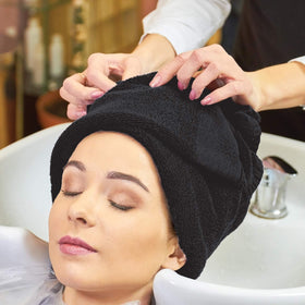 Arkwright towel wrapped on client by hairstylist for quick-dry convenience