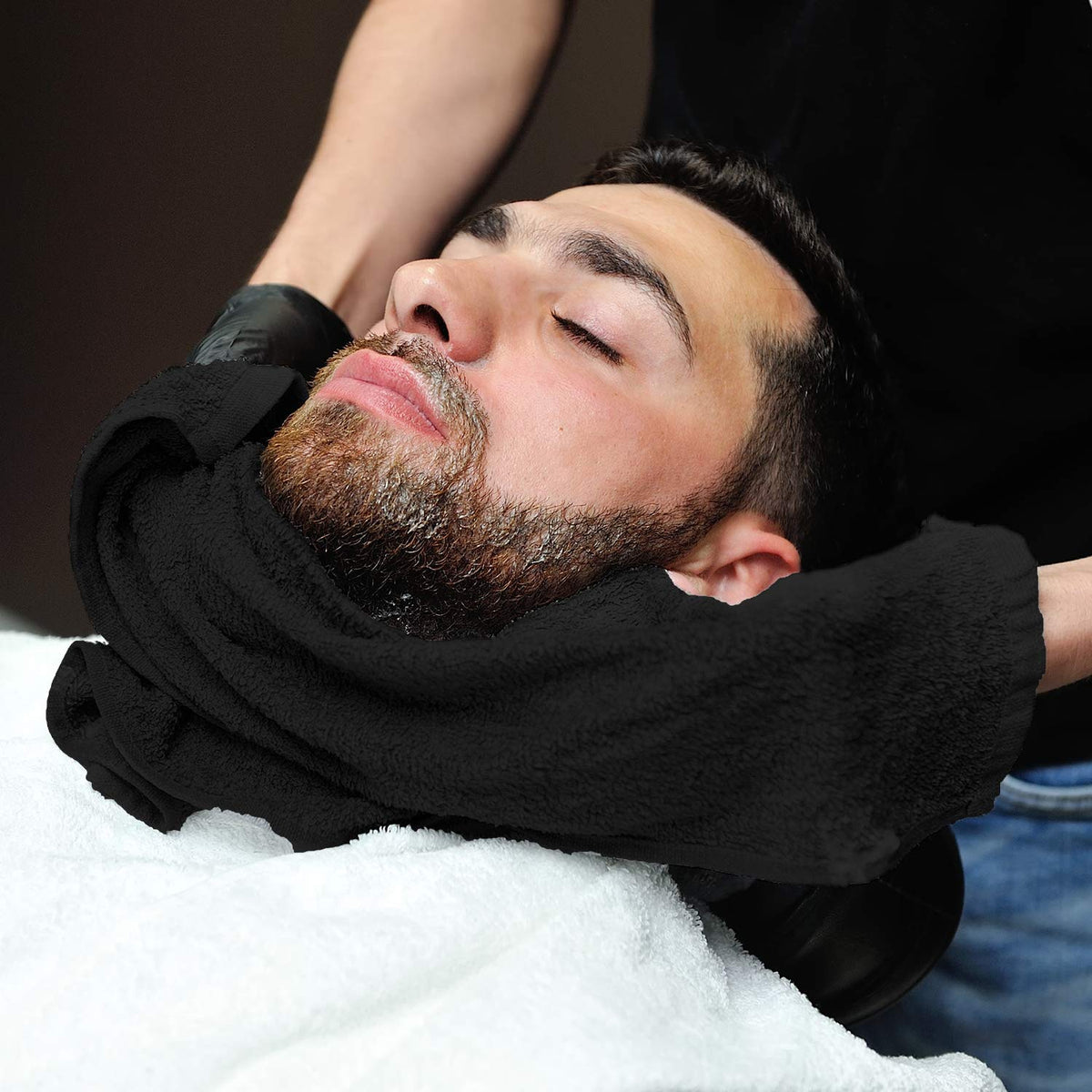 Arkwright towel beside hand showing 16x27 size for salon coverage