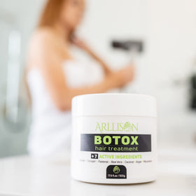 Flat iron sealing treated strand to lock in Arllison smoothness and long-lasting shine
