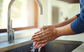 Arm & Hammer bottle next to a hand for scale showing compact, countertop-friendly size