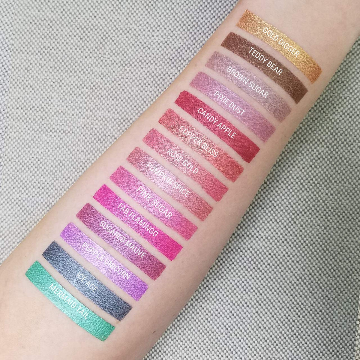 Aromi arm swatch showing vibrant magenta payoff and shimmer benefit: true-to-color preview