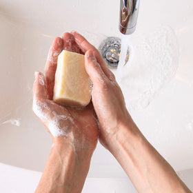 Artemis Organic Soaps loaf on cutting board mid-slice showing simple home preparation benefit