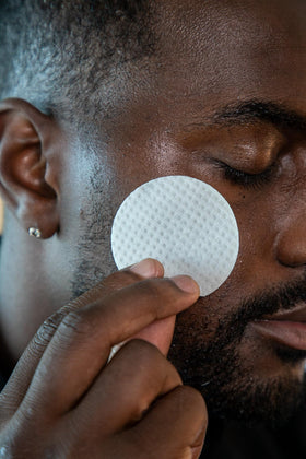ASSEMBLED wipe in hand wiping face to show easy pre-shave use