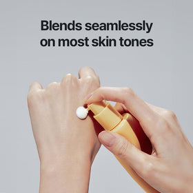 athé yellow-tinted essence on hand demonstrating no white cast benefit