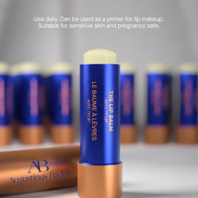 Augustinus Bader lip balm tucked into a bag pocket for on-the-go hydration