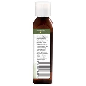 Aura Cacia oil drop on surface showing silky, fast-absorbing texture benefit