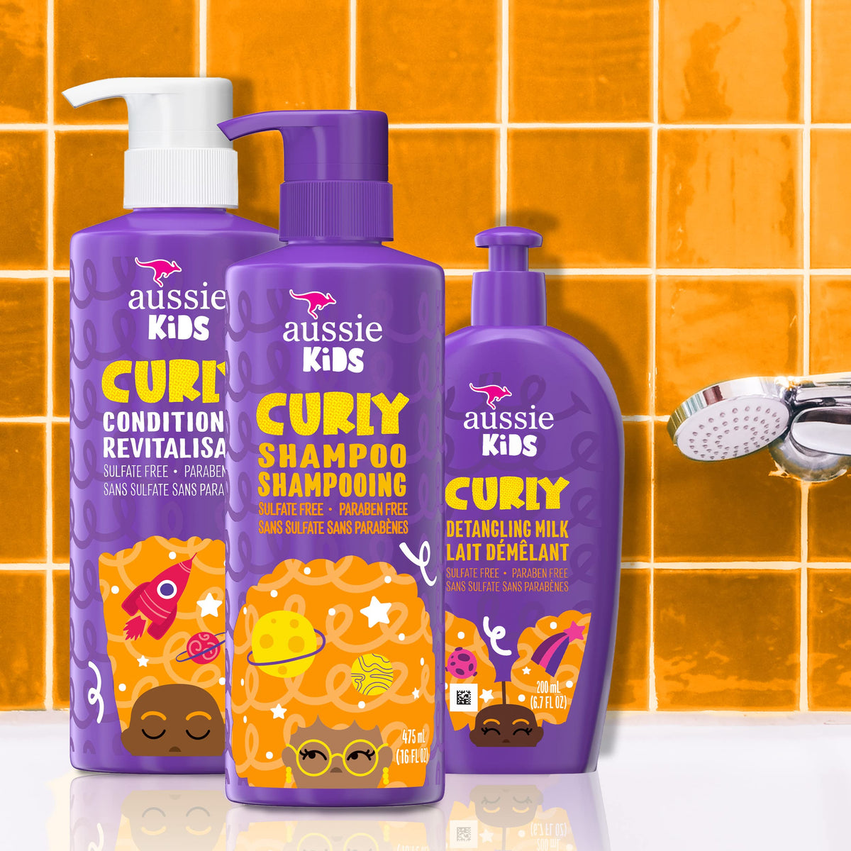 Aussie leave-in detangler spray being applied to damp curls for manageable hair
