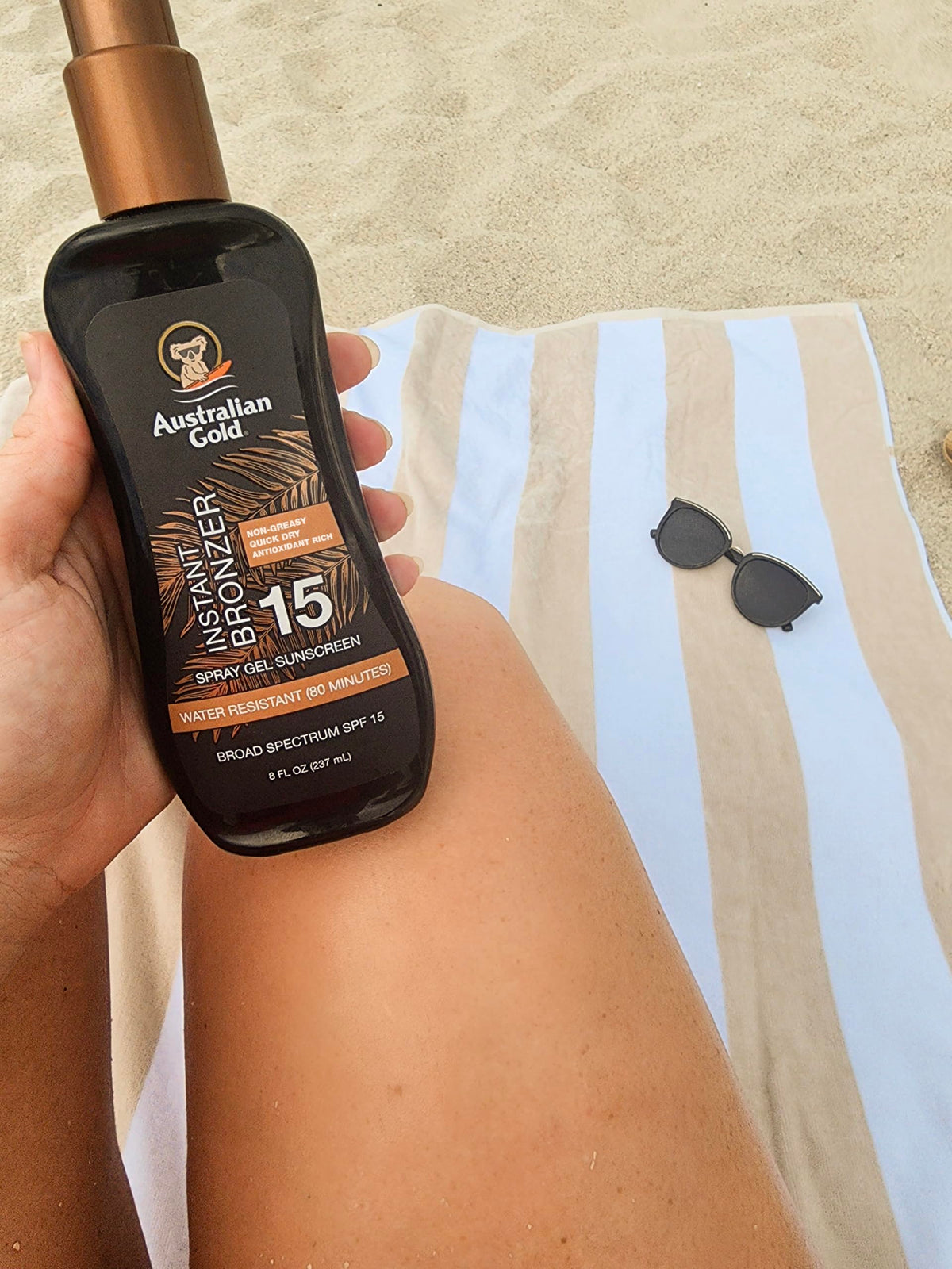 Australian Gold in a beach scene on towel showing water‑resistant sun protection benefits