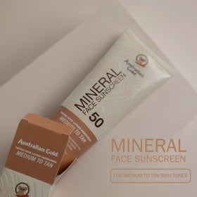 Australian Gold tube next to hand showing 2.5 fl oz size and portability benefit