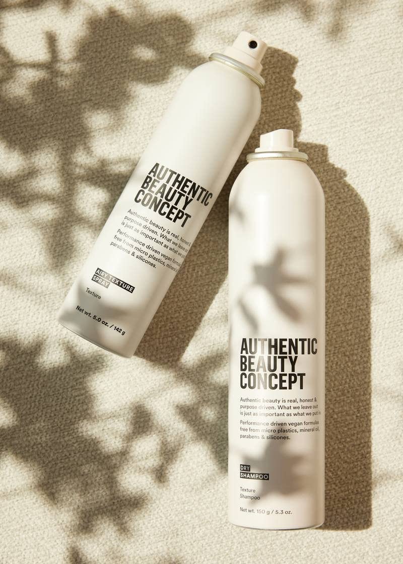Authentic Beauty Concept bottle next to hand for scale and travel-friendly portability